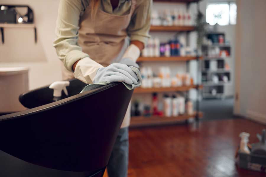 lady cleaning salon leather chair